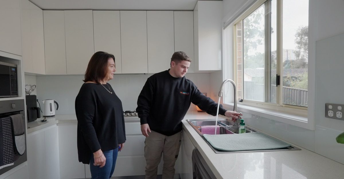 Tap testing with customer at the kitchen sink